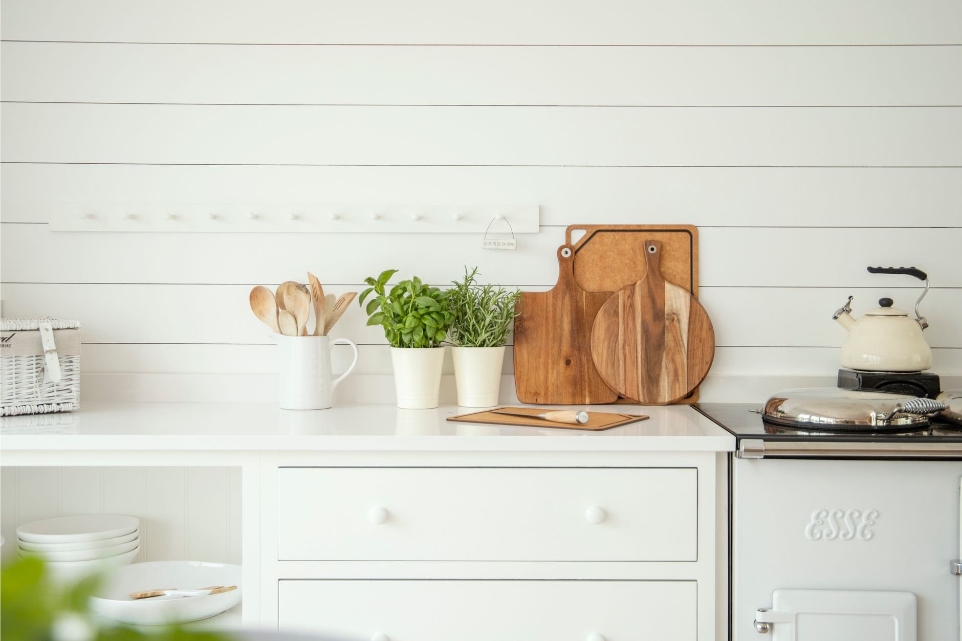 Stylish kitchen counter with herb pots, cutting boards, and utensils